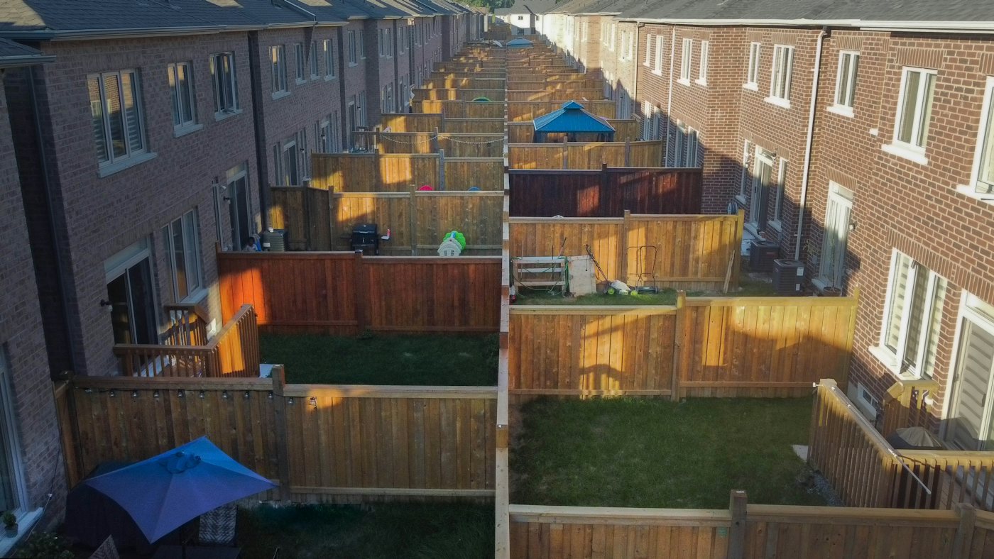 Aerial view of timber fencing and lawns between townhouse yards